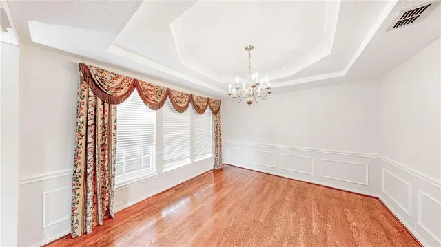a kitchen with stainless steel appliances granite countertop a sink a stove and a wooden floors
