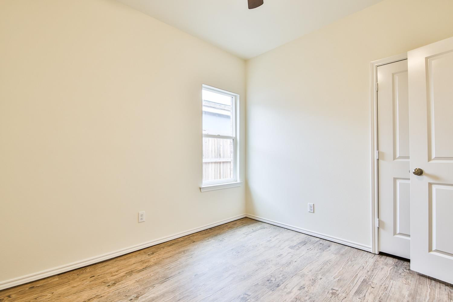 2004 23rd Street Lubbock, TX 79411 - Photo 13 of 26 an empty room with wooden floor and windows