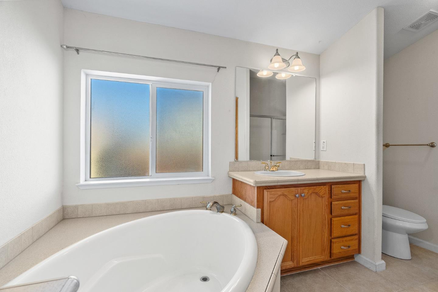 4160 Jade Street, Unit 72 Capitola, CA 95010 - Photo 12 of 23 a bathroom with a tub sink and mirror