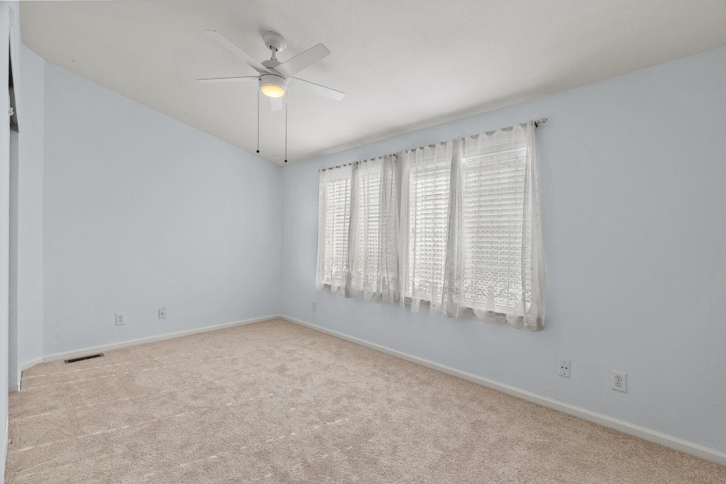 4160 Jade Street, Unit 72 Capitola, CA 95010 - Photo 13 of 23 an empty room with a window and a fan