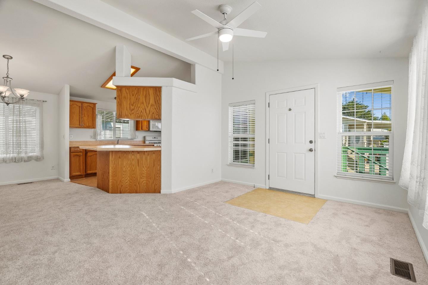 4160 Jade Street, Unit 72 Capitola, CA 95010 - Photo 4 of 23 an empty room with windows and cabinet