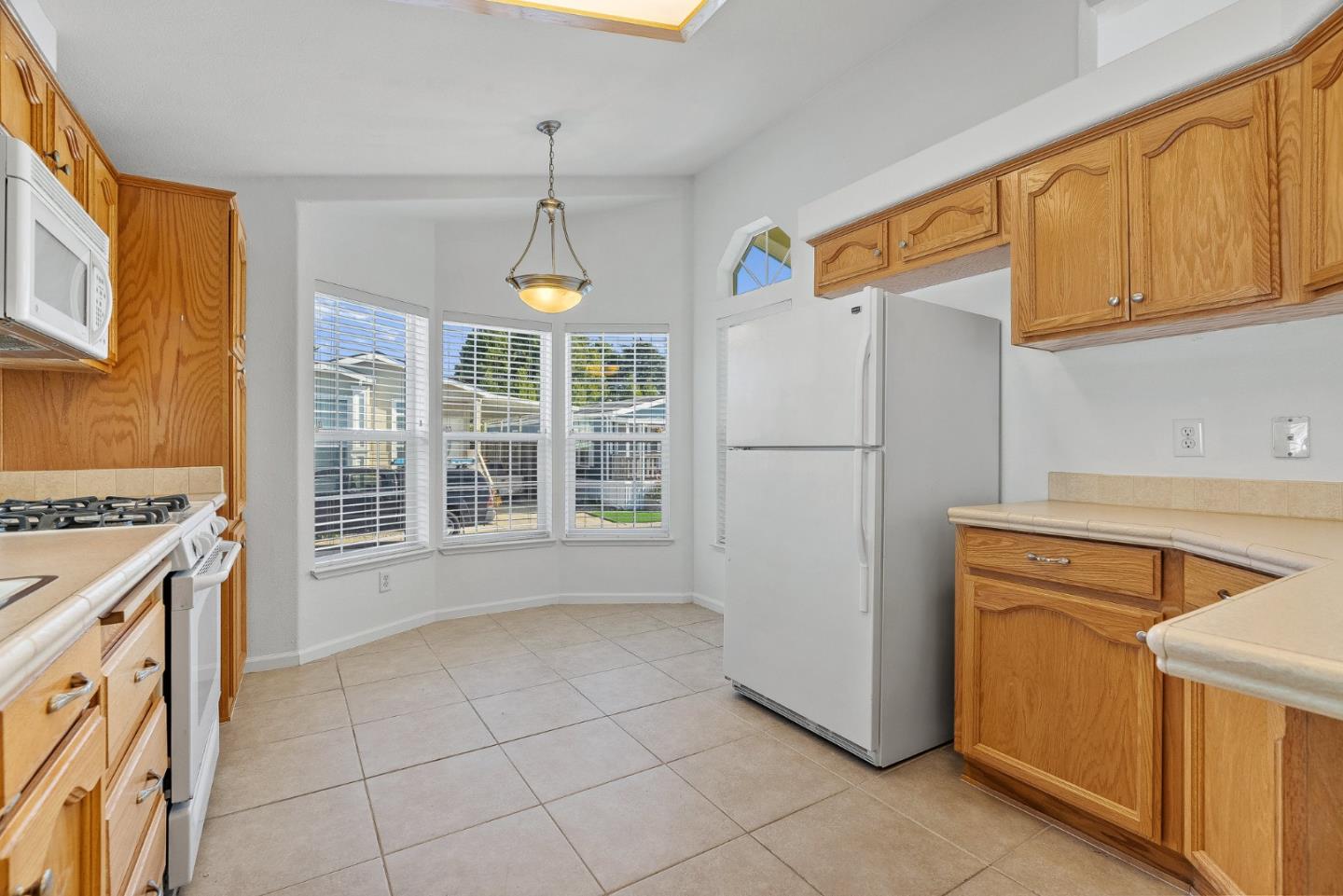 4160 Jade Street, Unit 72 Capitola, CA 95010 - Photo 8 of 23 a kitchen with a refrigerator a stove a sink and cabinets
