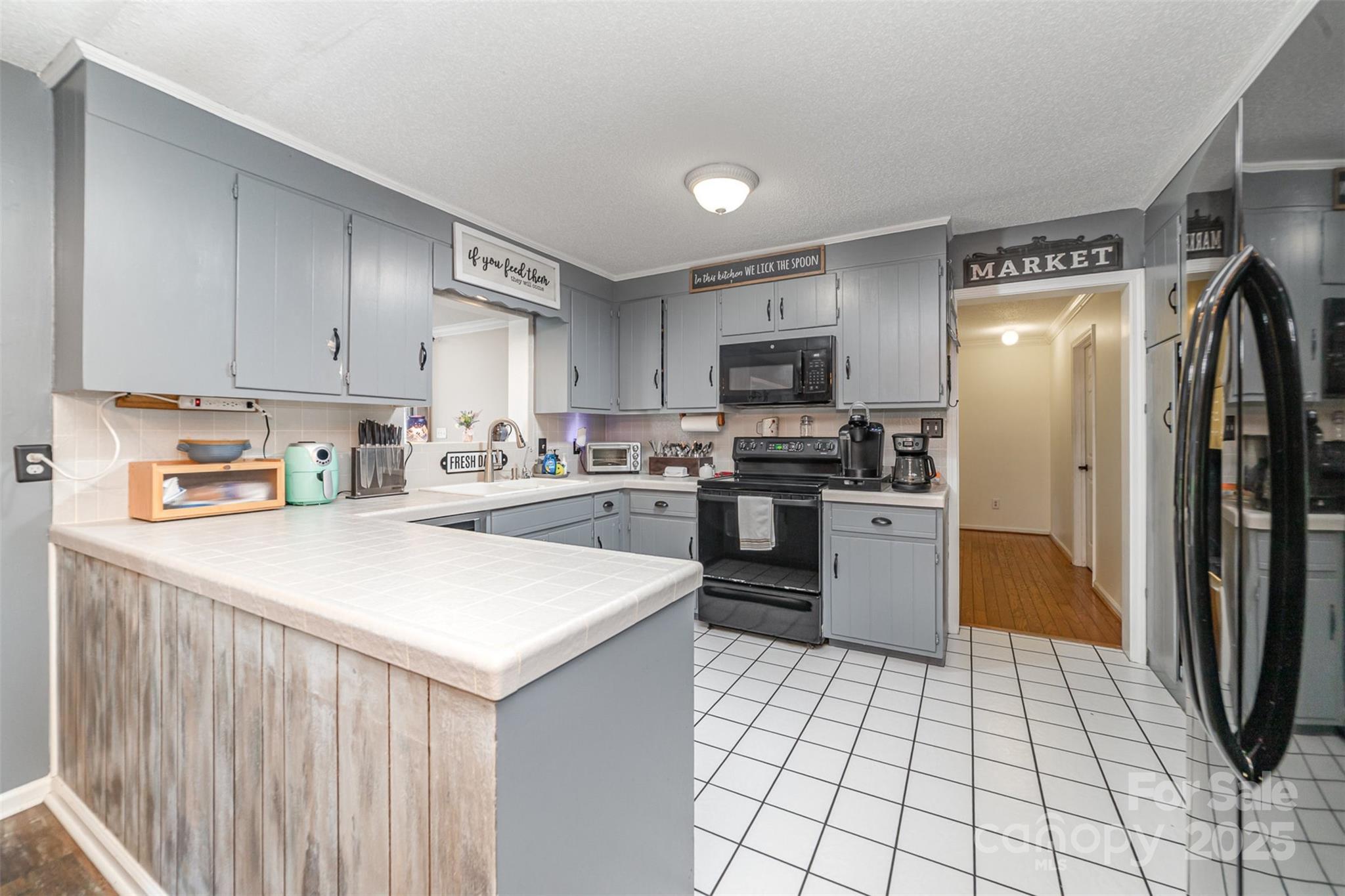 7430 Forney Hill Road Denver, NC 28037 - Photo 11 of 29 a kitchen with a sink a counter top space stainless steel appliances and cabinets