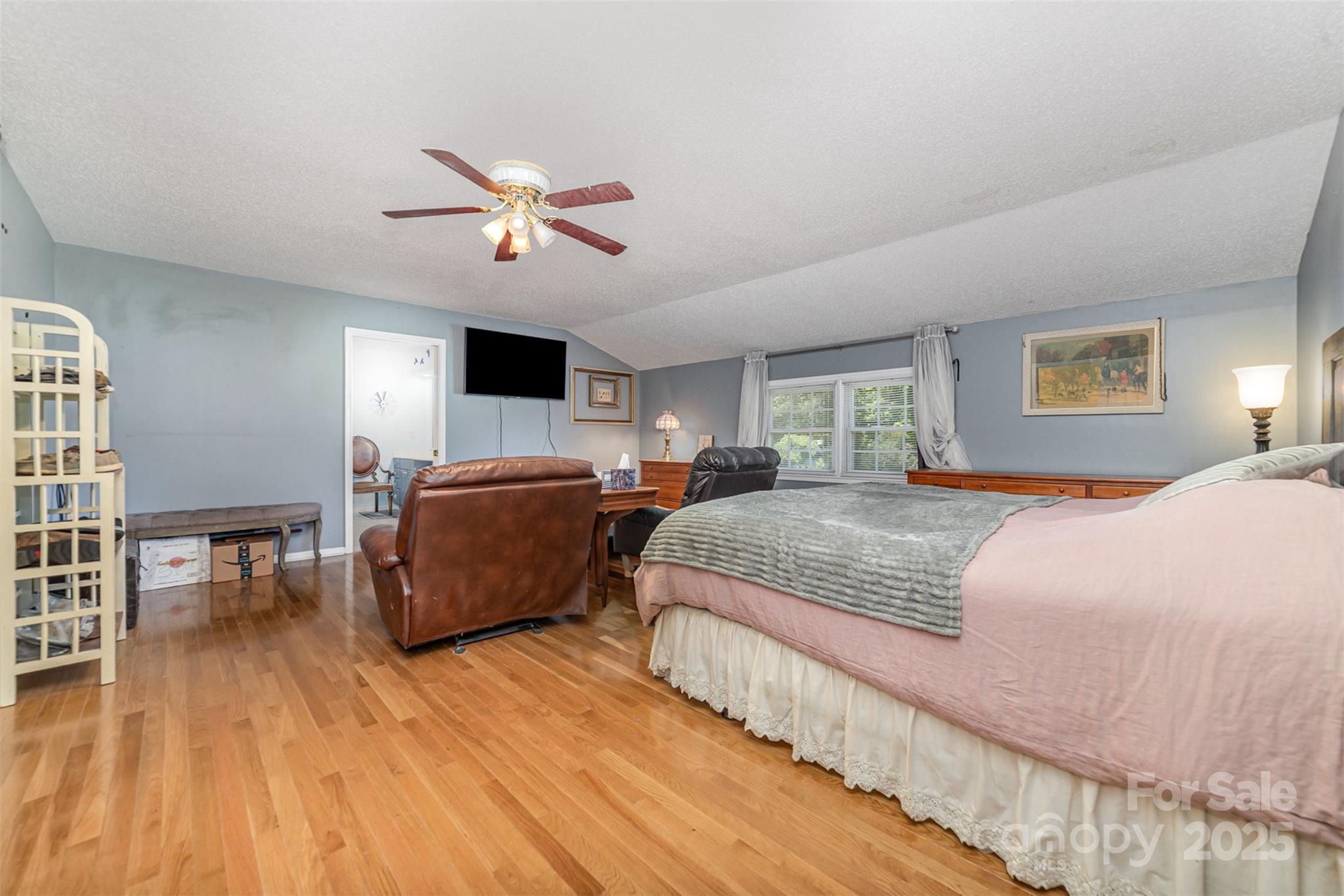 7430 Forney Hill Road Denver, NC 28037 - Photo 17 of 29 a bedroom with bed and a chandelier