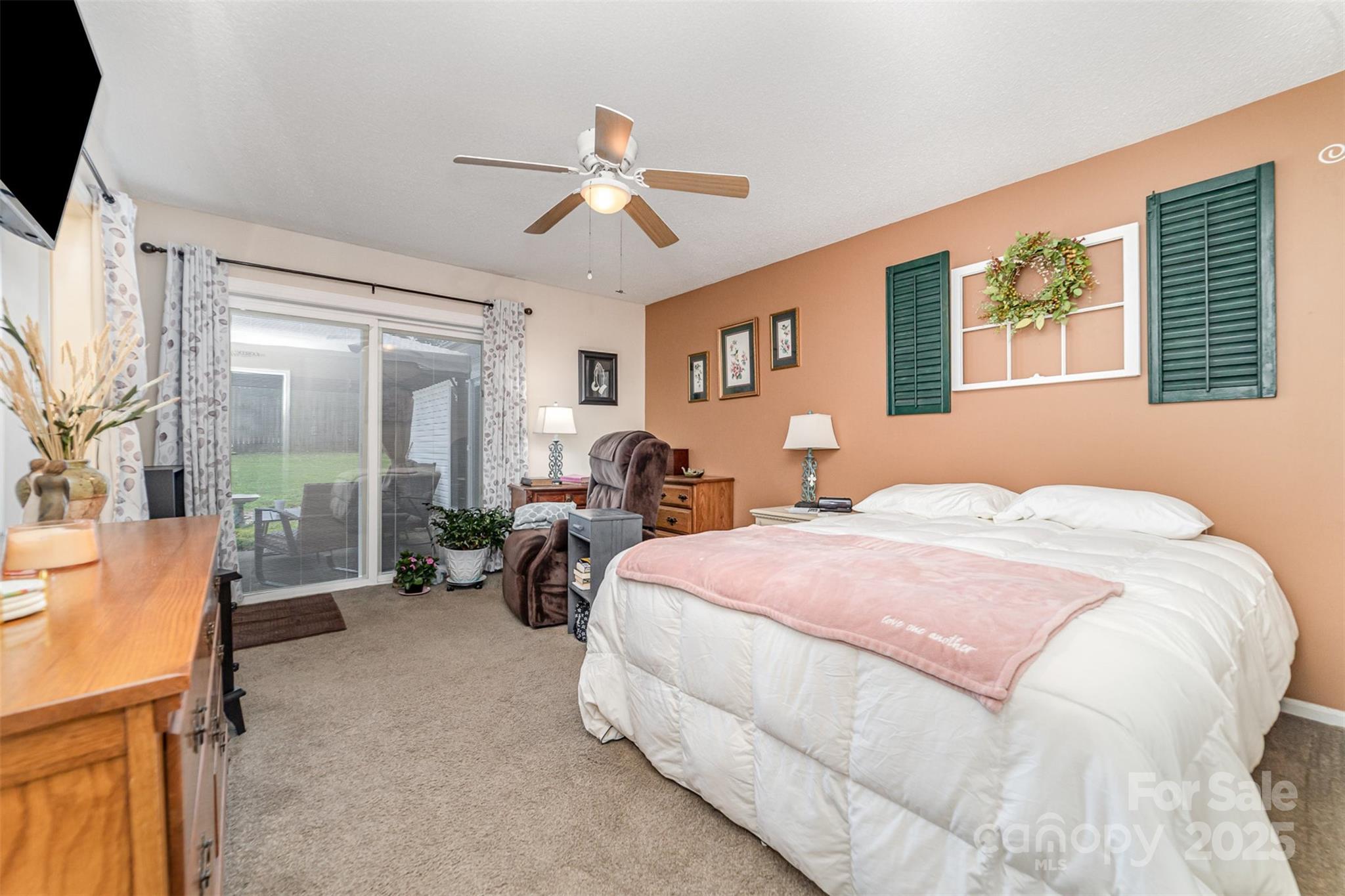 7430 Forney Hill Road Denver, NC 28037 - Photo 22 of 29 a spacious bedroom with a bed couch and a window