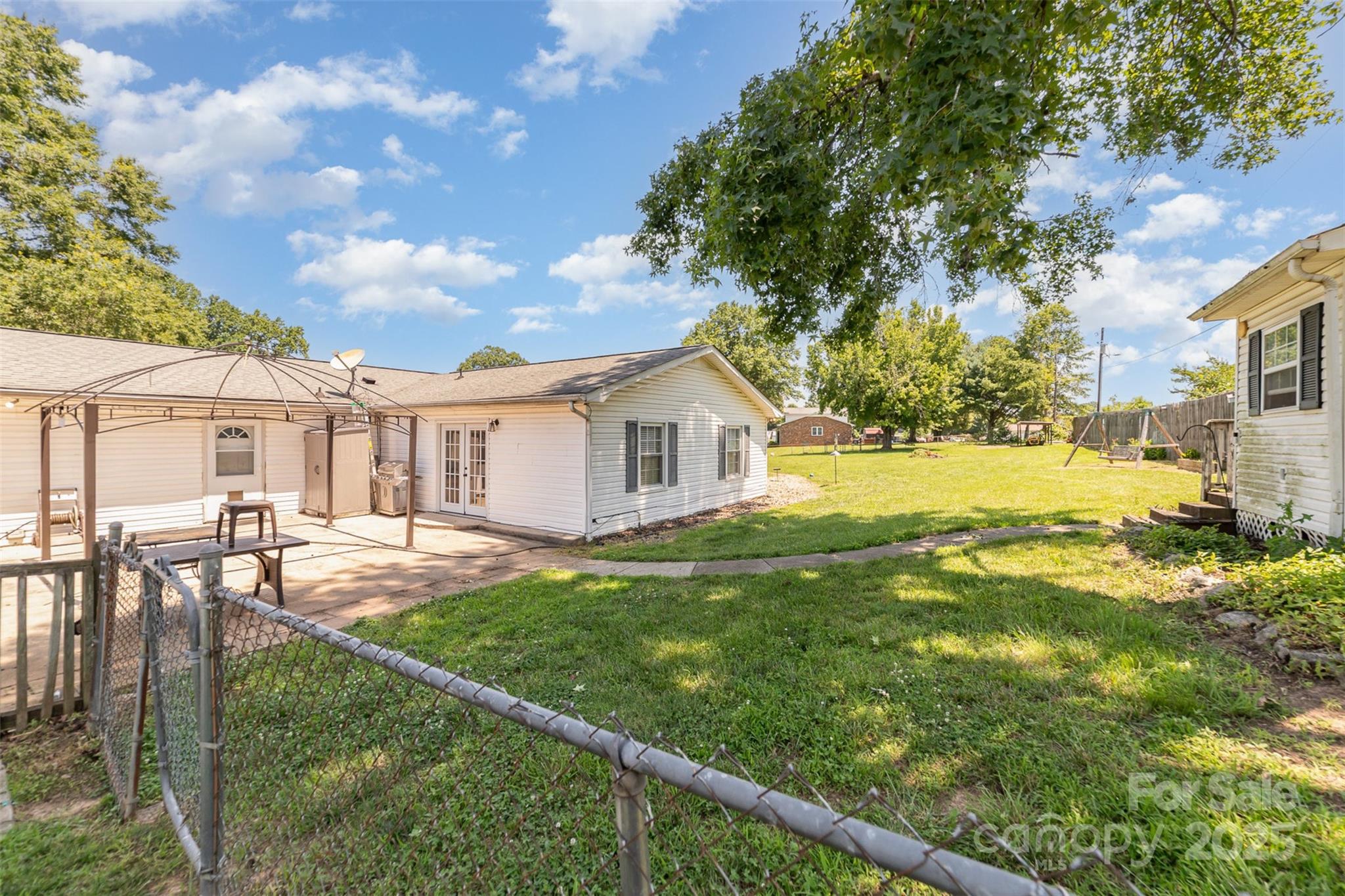7430 Forney Hill Road Denver, NC 28037 - Photo 26 of 29 a backyard of a house with table and chairs