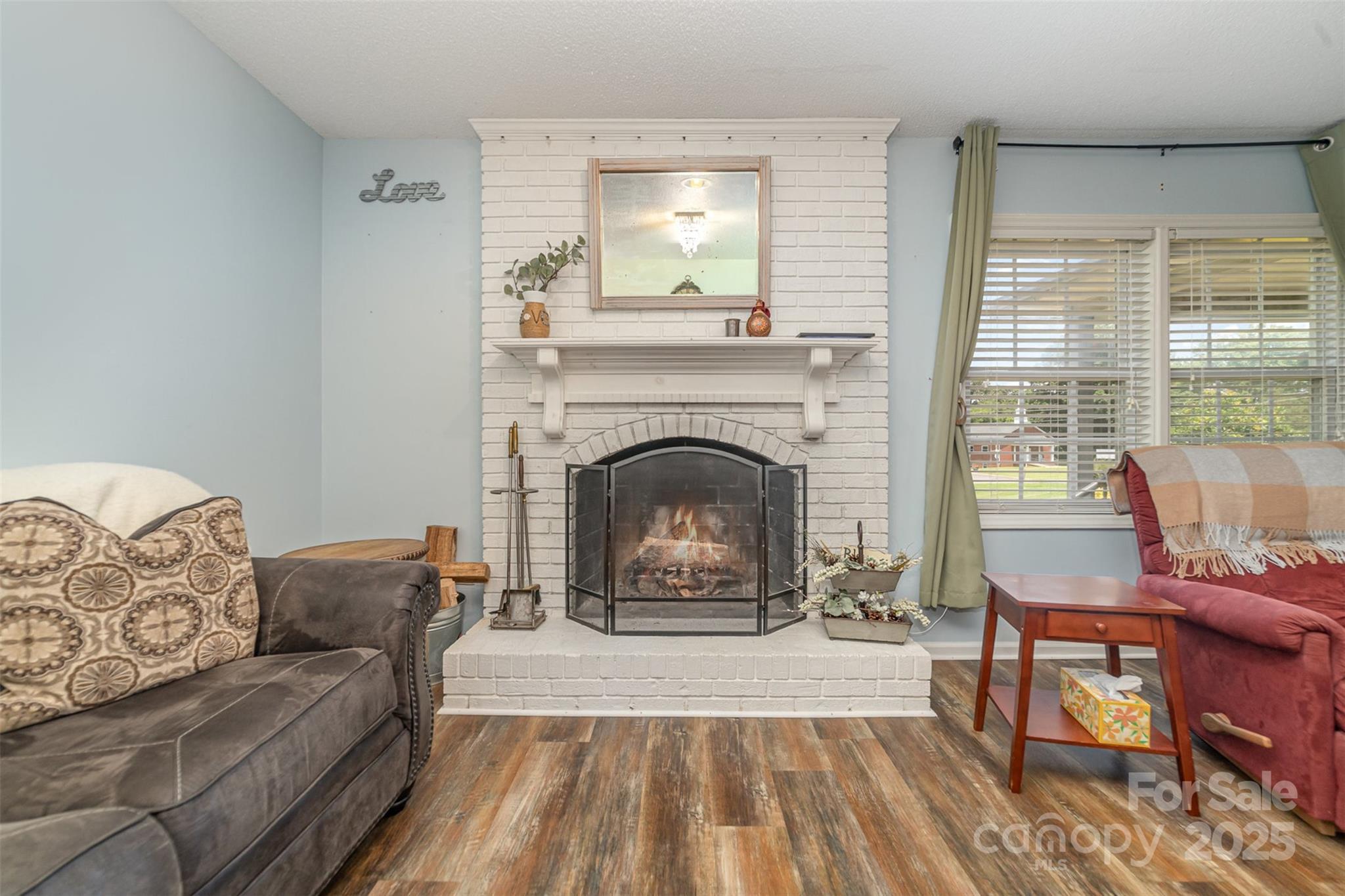 7430 Forney Hill Road Denver, NC 28037 - Photo 8 of 29 a living room with furniture and a fireplace