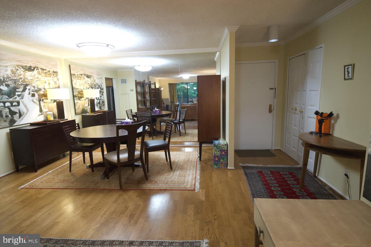 1800 Old Meadow Road, Unit 818 McLean, VA 22102 - Photo 6 of 35 a view of a dining room with furniture window and wooden floor