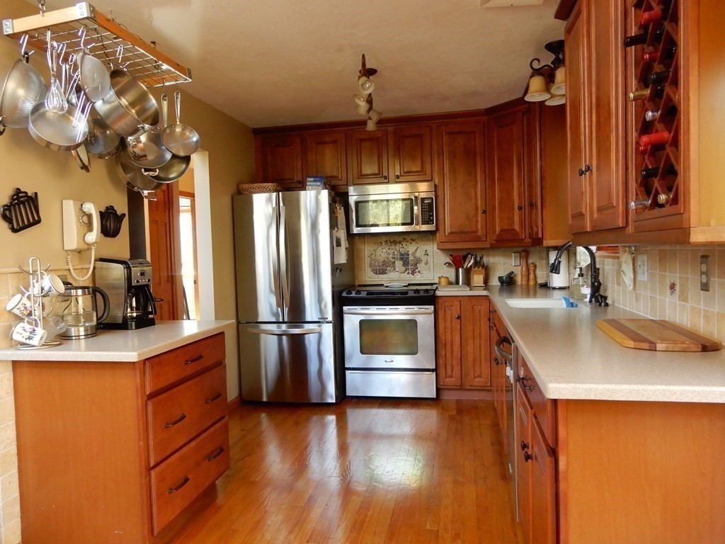 1013 Town Farm Road Warren, MA 01083 - Photo 25 of 38 a kitchen with stainless steel appliances granite countertop a sink a stove a refrigerator cabinets and wooden floor