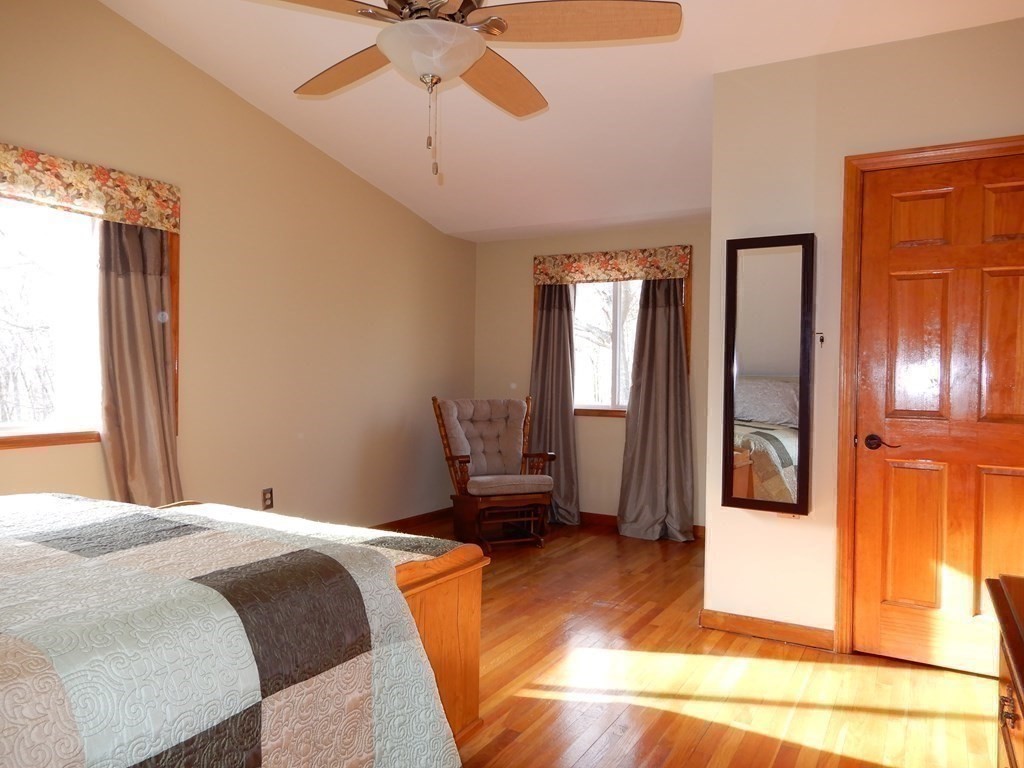 1013 Town Farm Road Warren, MA 01083 - Photo 31 of 38 a bedroom with a bed and a chandelier