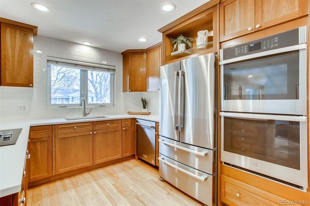 a kitchen with stainless steel appliances granite countertop a refrigerator and a microwave