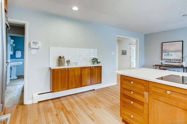 a kitchen with wooden floors and a sink