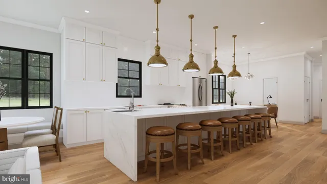 a view of a kitchen area with furniture and wooden floor