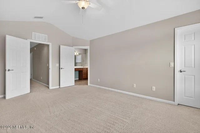 a view of an empty room with a kitchen