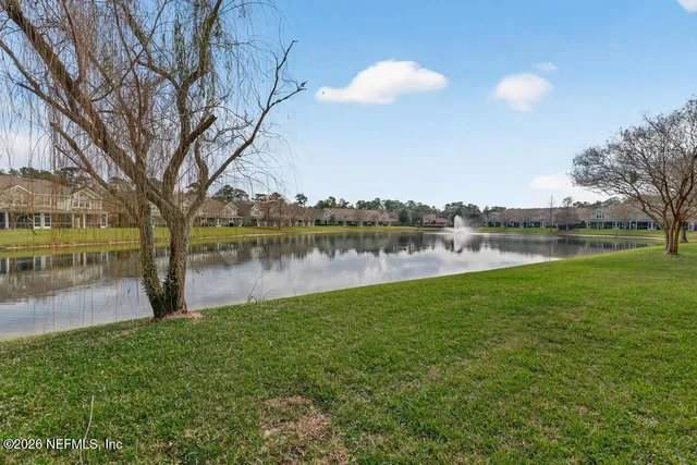 a view of a lake with houses in the back
