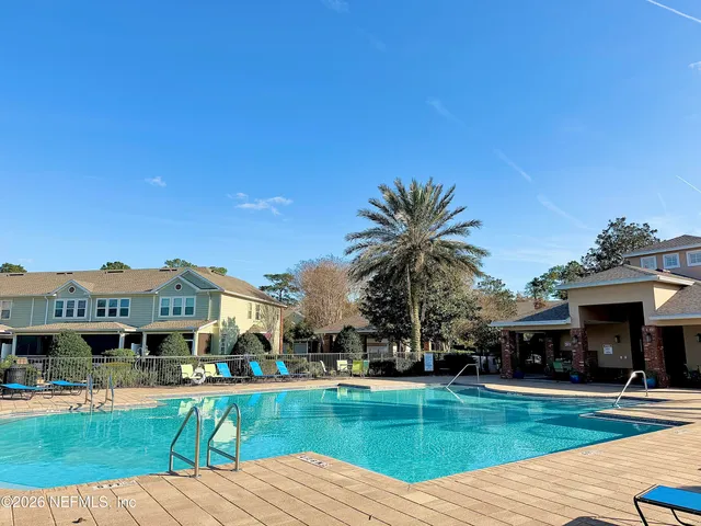 a view of a house with swimming pool and a yard