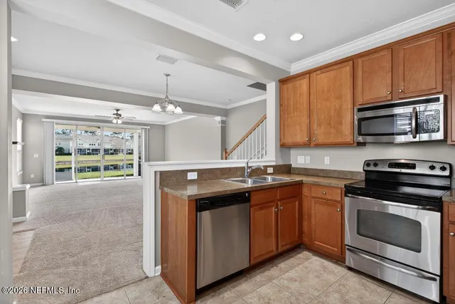a kitchen with appliances cabinets and a sink