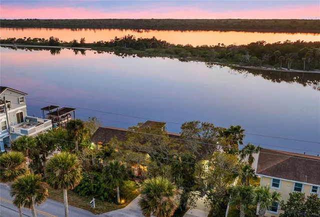 a view of a balcony with wooden floor and outdoor seating