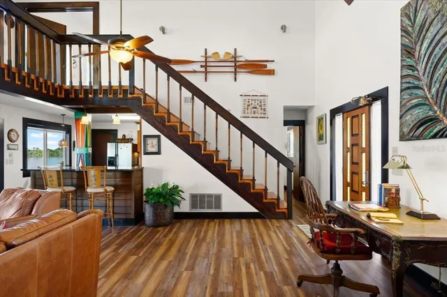 a view of a livingroom with wooden floor and a fireplace