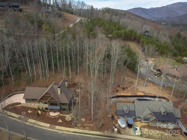a view of a house with a yard and mountain view