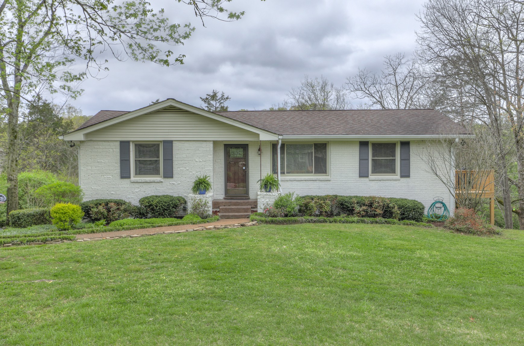 1217 Davidson Road Nashville, TN 37205 - Photo 2 of 43 a front view of a house with a garden
