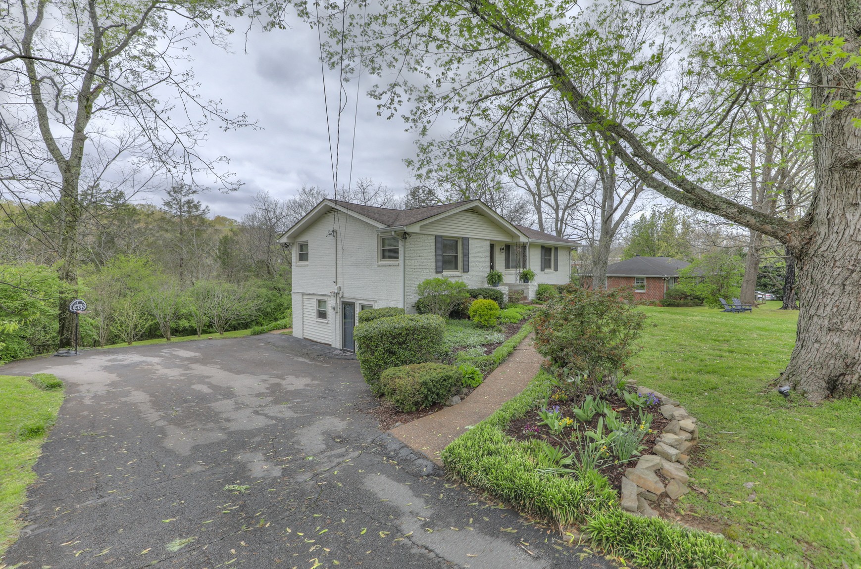 1217 Davidson Road Nashville, TN 37205 - Photo 3 of 43 a front view of a house with a yard and large trees