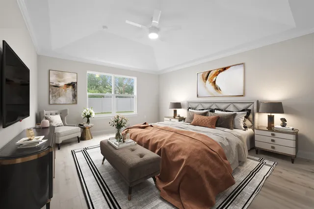 a bedroom with furniture and a flat screen tv