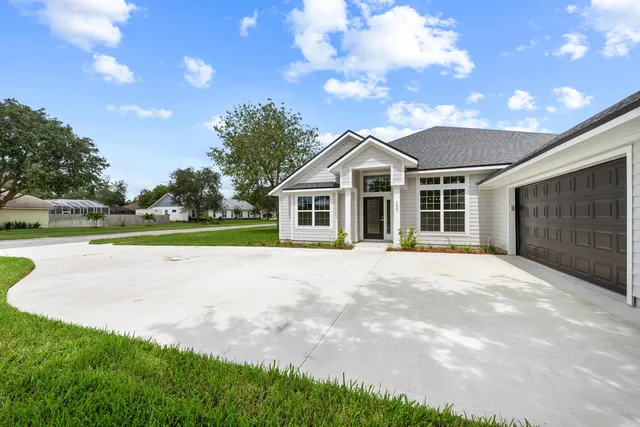 a view of a house with a yard and garage