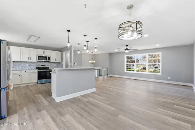 a bathroom with a granite countertop sink a toilet and a shower