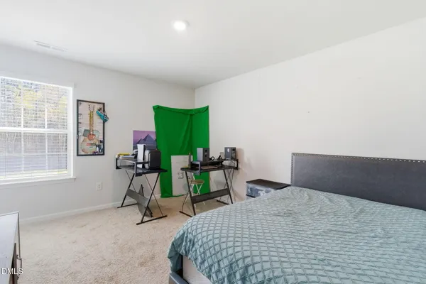 a bedroom with a bed a desk and chair