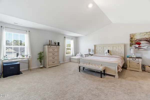 a spacious bedroom with a bed and a window