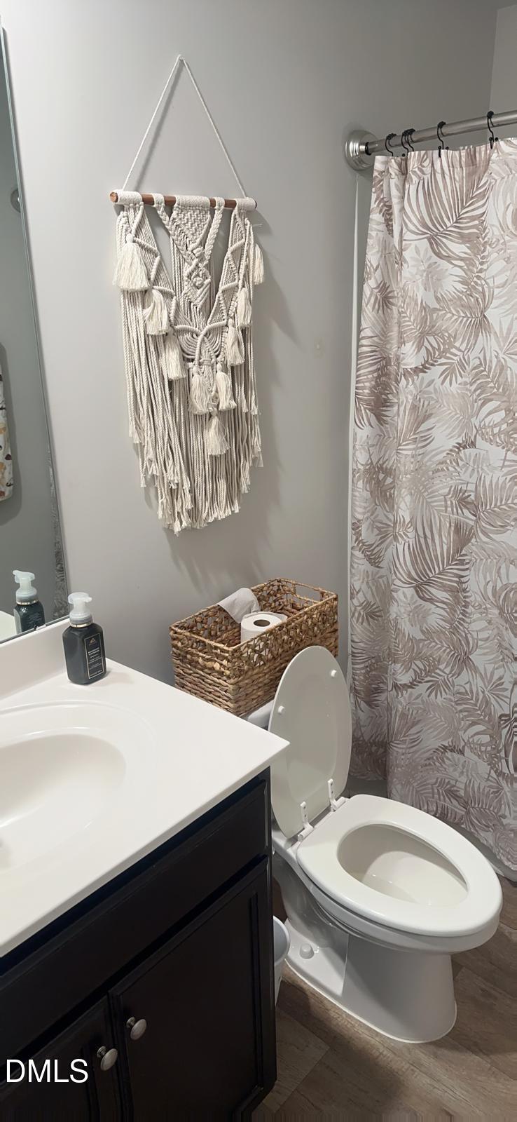 7643 Jordan Road Rocky Mount, NC 27803 - Photo 17 of 23 a bathroom with a sink a toilet and shower curtain