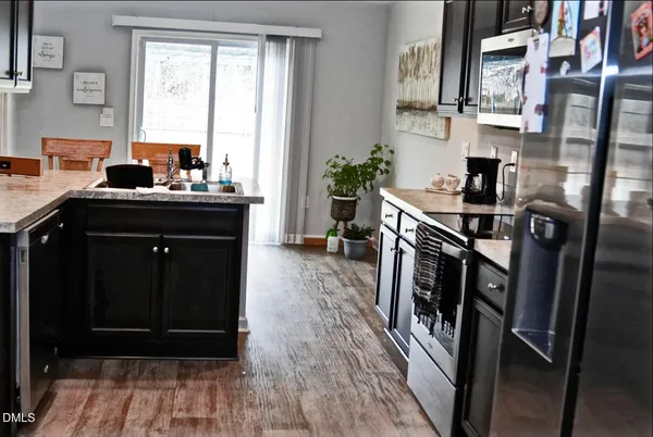 a kitchen with a sink appliances and a window