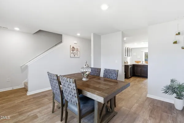 a view of a dining room with furniture and wooden floor