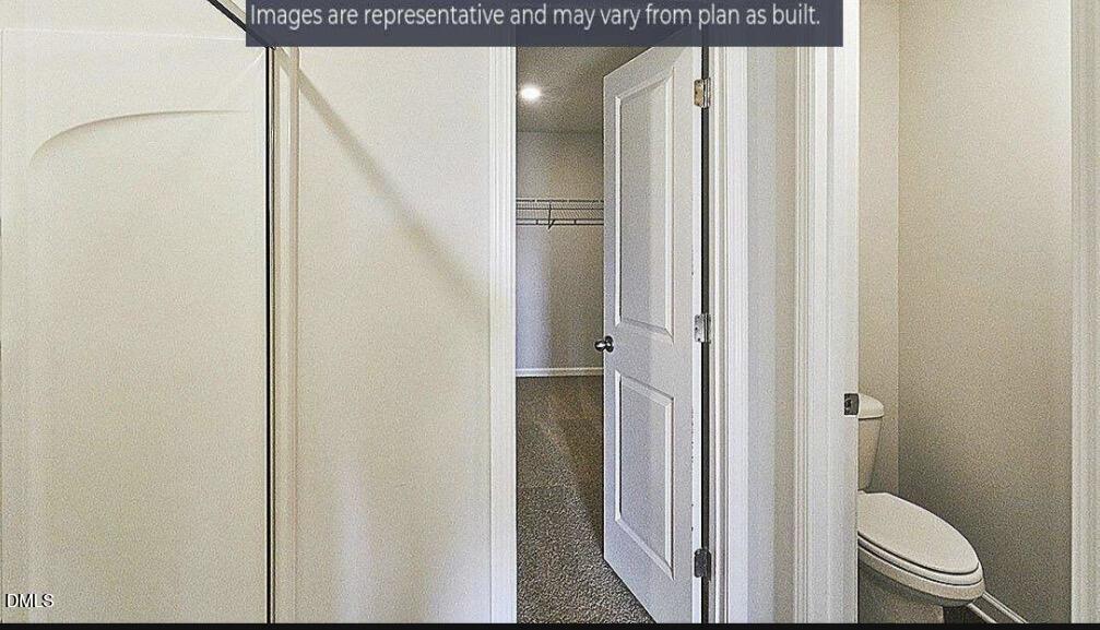 7643 Jordan Road Rocky Mount, NC 27803 - Photo 7 of 23 a bathroom with a granite countertop toilet and a shower