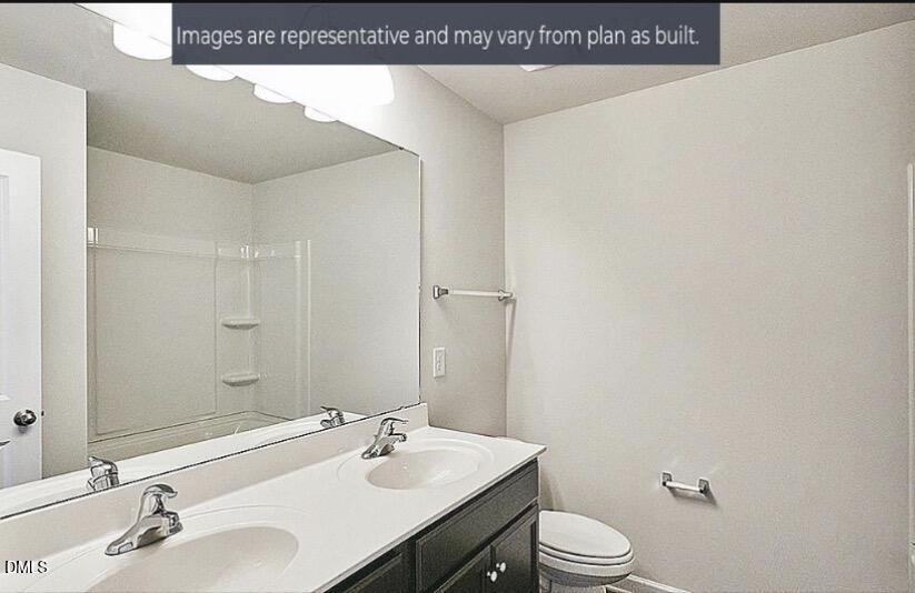 7643 Jordan Road Rocky Mount, NC 27803 - Photo 8 of 23 a bathroom with a sink a toilet and mirror