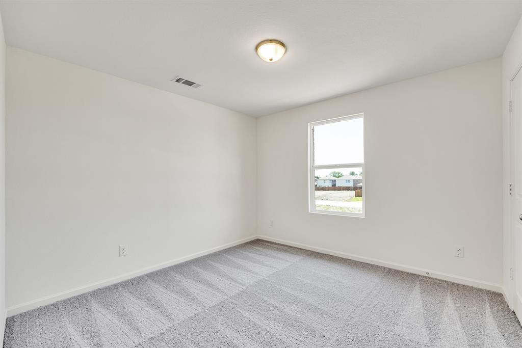 1707 Washington Street Princeton, TX 75407 - Photo 11 of 21 an empty room with a window