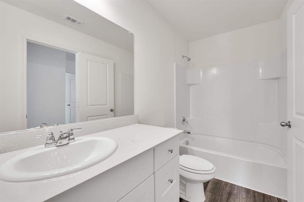 1707 Washington Street Princeton, TX 75407 - Photo 19 of 21 a bathroom with a sink a toilet and shower