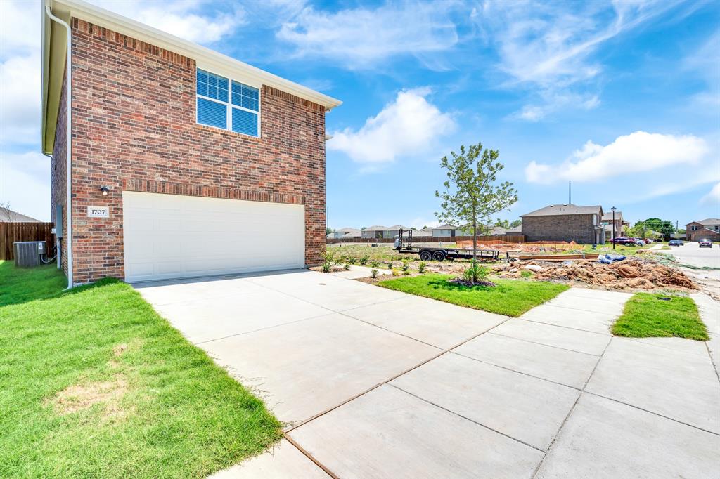 1707 Washington Street Princeton, TX 75407 - Photo 2 of 21 a view of a backyard with plants and palm trees