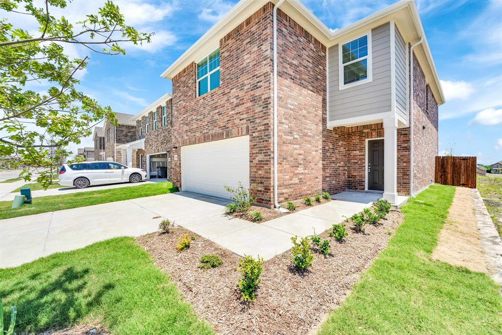 1707 Washington Street Princeton, TX 75407 - Photo 3 of 21 a front view of a house with a yard and garage