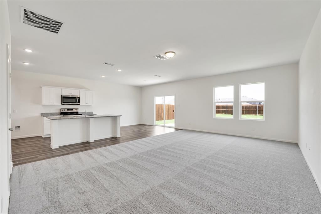 1707 Washington Street Princeton, TX 75407 - Photo 4 of 21 a view of kitchen with stainless steel appliances granite countertop a stove top oven a sink and a refrigerator