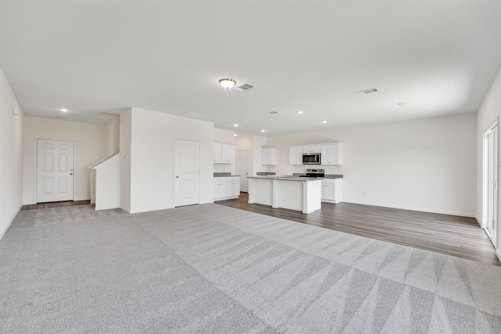 1707 Washington Street Princeton, TX 75407 - Photo 5 of 21 a view of large kitchen with a refrigerator and a stove top oven