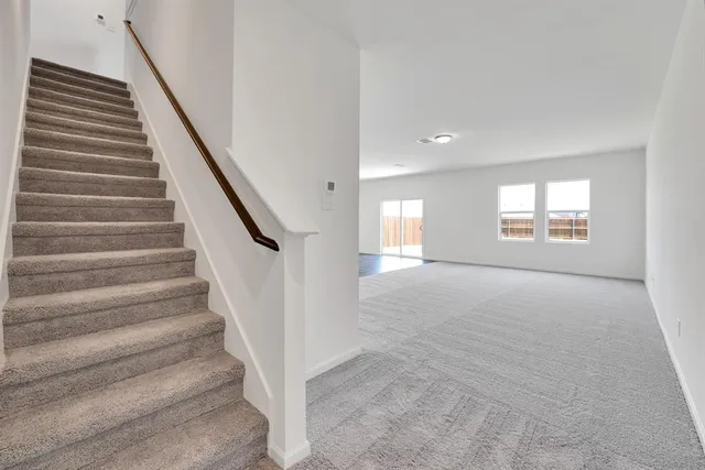 a view of an empty room with windows