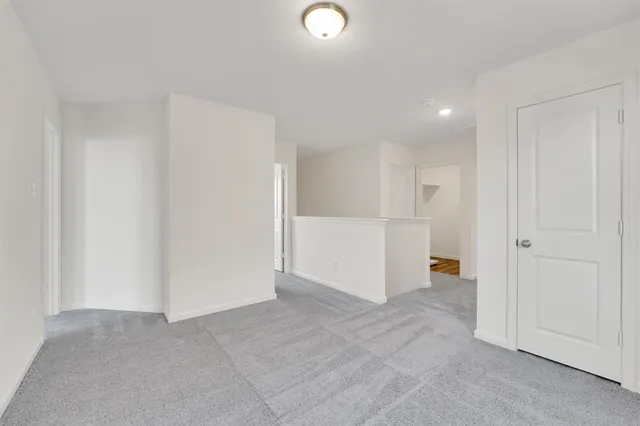 a view of an empty room and closet area