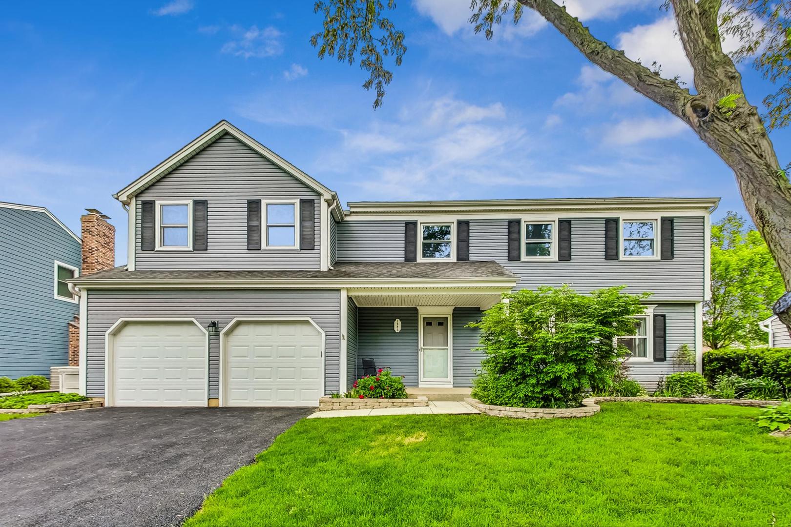 1329 East Bailey Road Naperville, IL 60565 - Photo 1 of 48 a front view of a house with a yard and garage