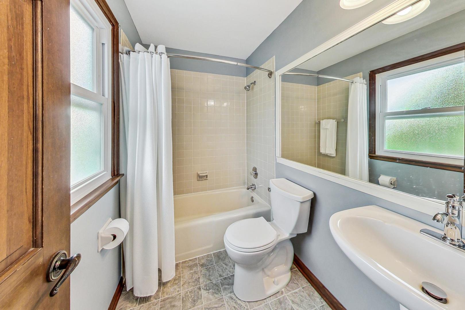 1329 East Bailey Road Naperville, IL 60565 - Photo 30 of 48 a bathroom with a toilet a sink and a bathtub
