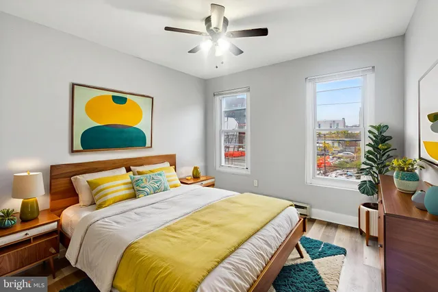a bedroom with a bed and a potted plant