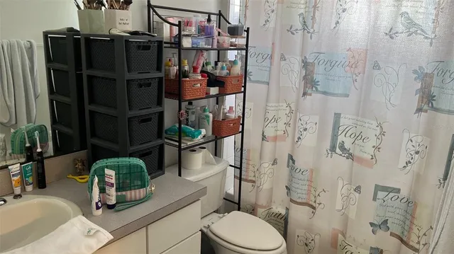 a bathroom with a sink toilet and shower