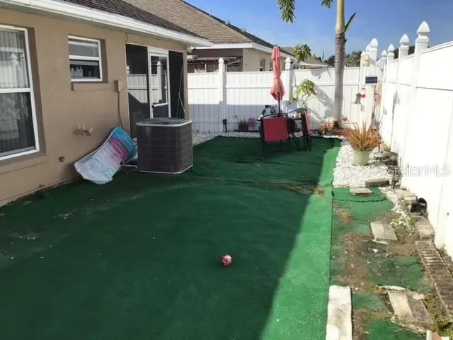 a front view of a house with a garden and patio
