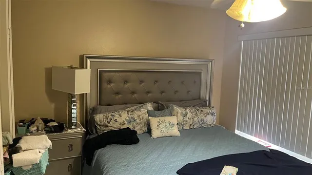 a bedroom with a bed and a chandelier